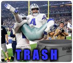 Cowboys player lifted into a trash can, captioned TRASH